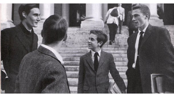 A boy speaking to college students.