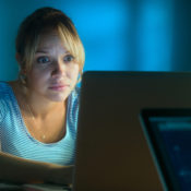Woman at a computer, late at night