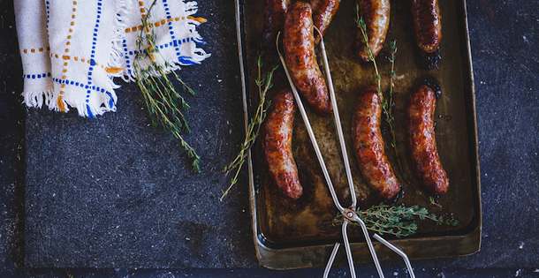 Sausage in tongs