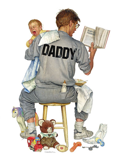 A father holding a baby, while balancing a bowl of baby food on his knee and reading a book in his free hand.