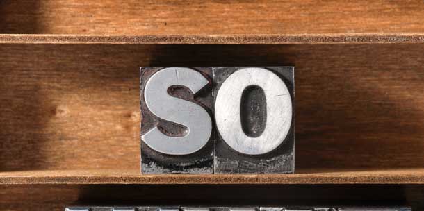 The word "So" in typeface on a shelf