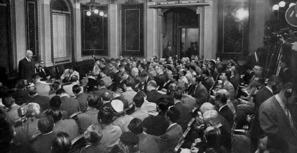 Dwight D. Eisenhower gives a speech conference at the White House before reporters.