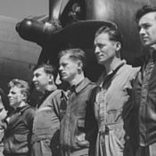 Members of the Army Air Corps stand at attention in front of one of their planes