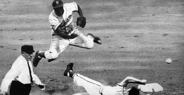 Jackie Robinson throwing over a slider player