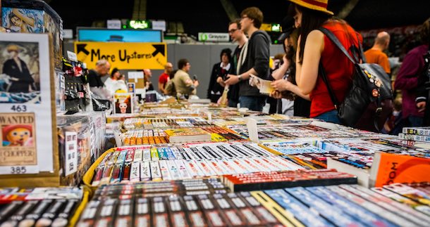 Comic convention attendees browsing Japanese manga