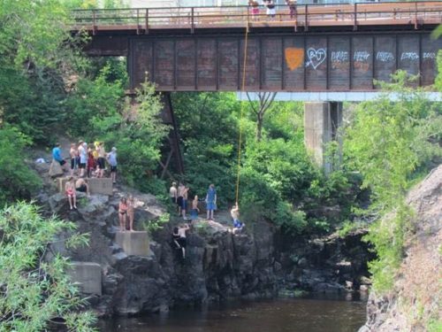 People playing under a bridge