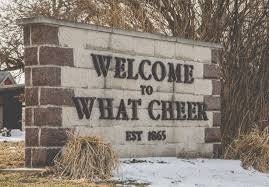 Stone sign reading "Welcome to What Cheer"