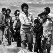 Vietnamese refugees walking ashore