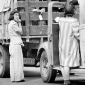 Japanese-American residents loading household belongings onto trucks.