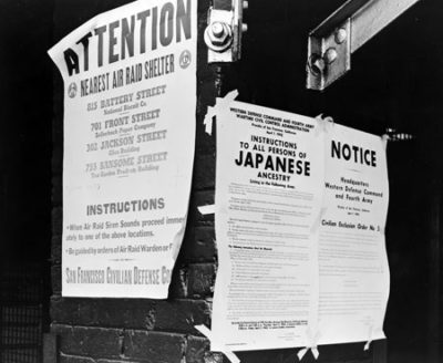 Notices on a telephone pole directing removial of Japnese-American citizens