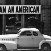 A sign reading "I AM AMERICAN" outside of a grocery store