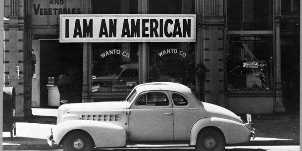 A sign reading "I AM AMERICAN" outside of a grocery store