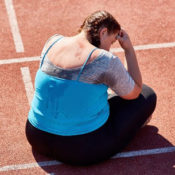 Tired runner sitting on a race track