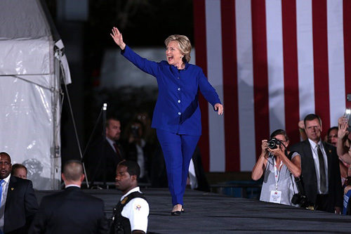 Hillary Clinton walks on stage during the 2016 campaign. She's wearing one of the pantsuits that became part of her image.