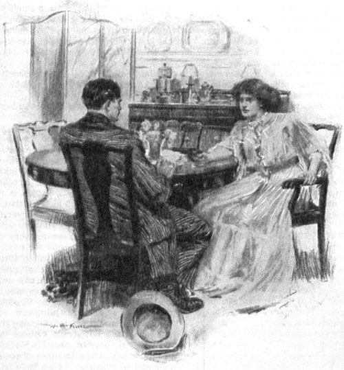 Woman talking to a man at a table.