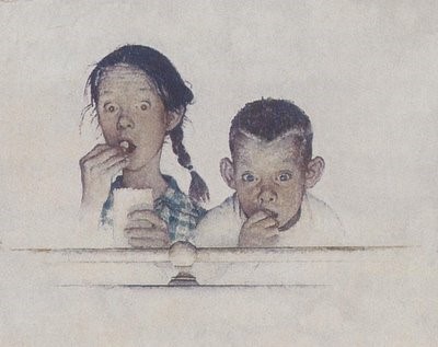 Boy and girl eating popcorn while watching a movie