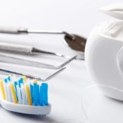 Dental tools, such as a toothbrush, floss, and a cleaning pick.