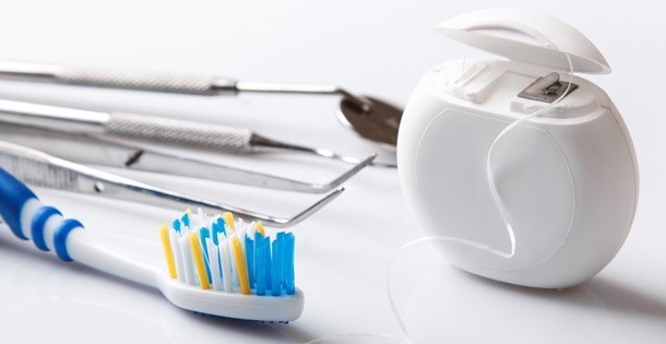 Dental tools, such as a toothbrush, floss, and a cleaning pick.