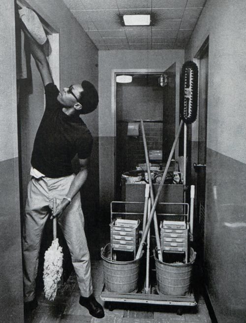 James Price cleaning toilets in a bathroom