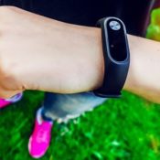 Woman's arm with a health monitoring device hung on her wrist.