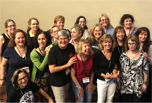 Women cartoonists pose for a photo.