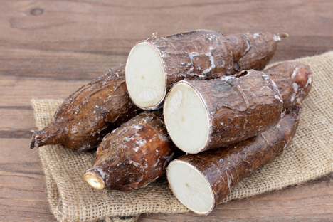 Sliced yuca on a wooden table.