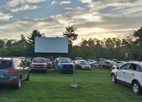 A drive-in theatre on a grassy lawn.