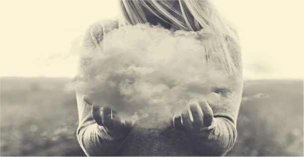 Woman holding a cloud, symbolizing a thought.