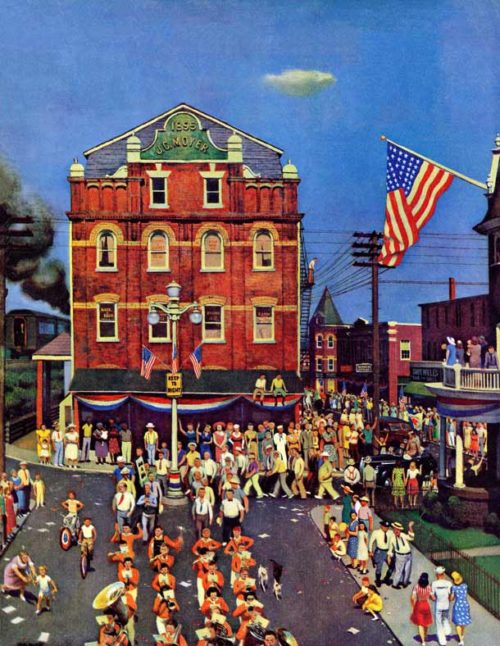 Brass band parades through the streets of a Pennsylvania town in view of spectators.