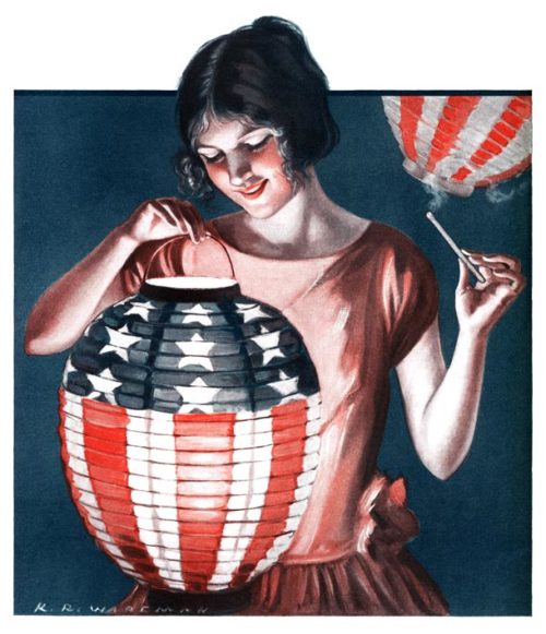 Young woman lights a Japanese paper lantern that's decorated with the U.S. flag.