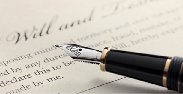 A fountain pen rests above a signature line of a will.