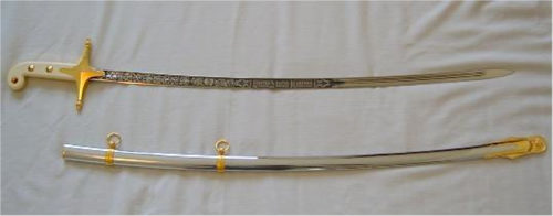 A mameluke sword and its scabbard on table cloth.