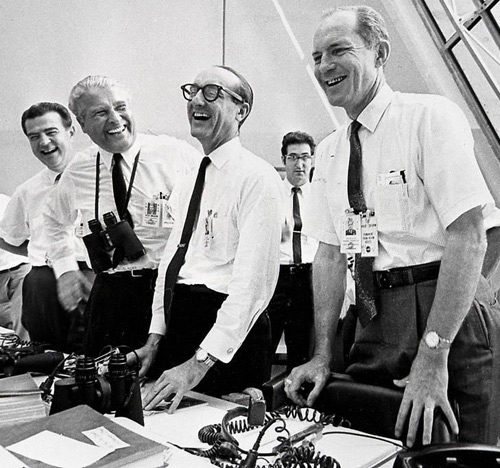 NASA scientists laughing during a meeting.