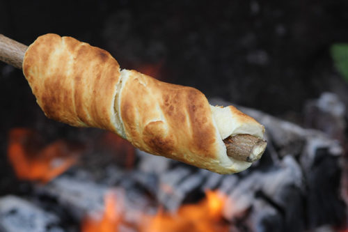 Bread cooking over a campfire