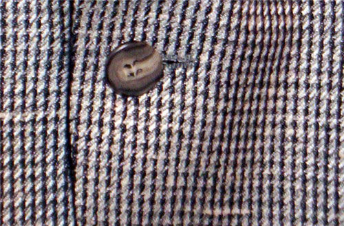 Close-up of a Houndsooth jacket and its button