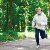 Elder man running in a wooded area