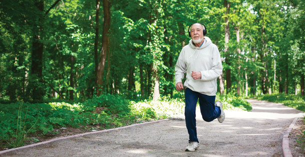 Elder man running in a wooded area