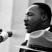 Martin Luther King, Jr. speaking into a microphone during his "I Have a Dream" speech.
