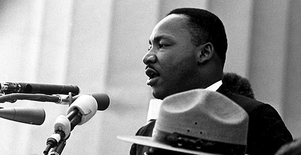 Martin Luther King, Jr. speaking into a microphone during his "I Have a Dream" speech.