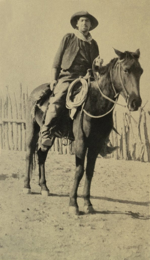 N.C. Wyeth in cowboy clothes sitting on a horse.