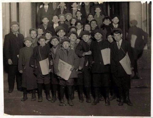 Newsboys with newspapers