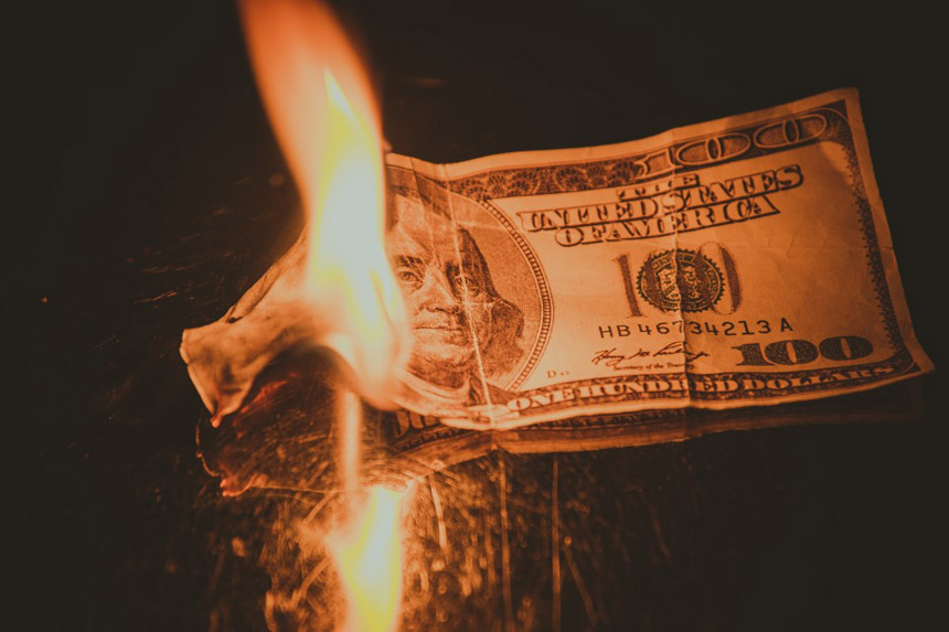 A $100 dollar bill on fire.