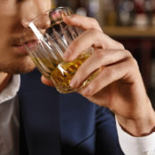 Man drinking alcohol out of a glass