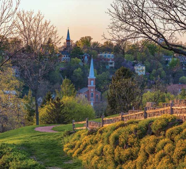 View of Galena, Illinois. Homes, churches, and lush trees can be seen.