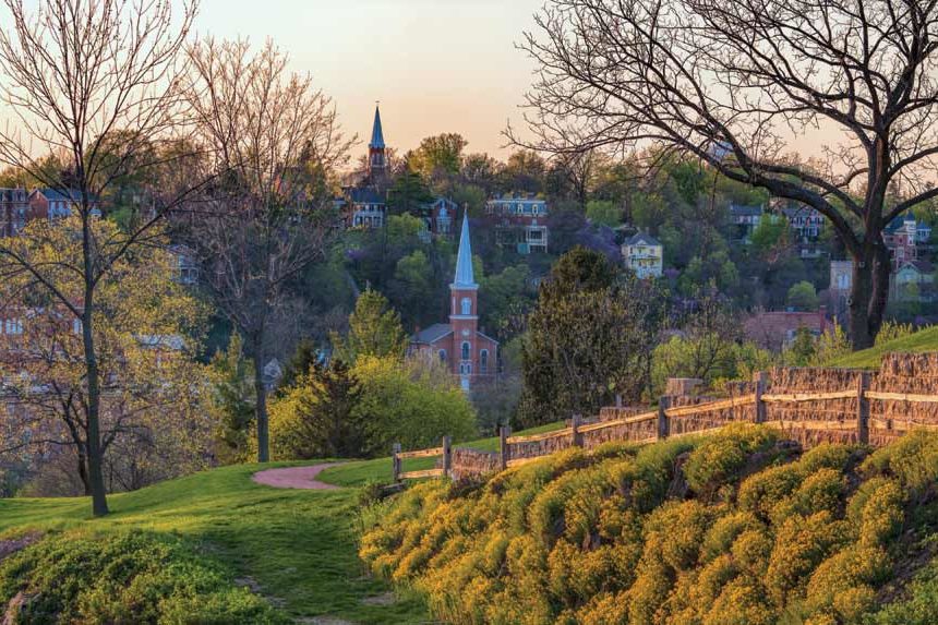 View of Galena, Illinois. Homes, churches, and lush trees can be seen.