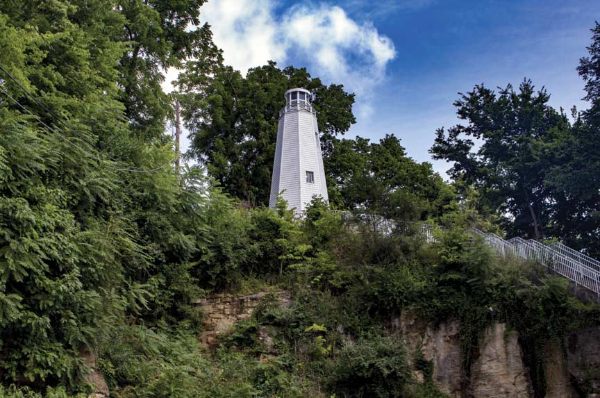 A lighthouse on a grassy cliff