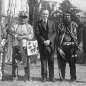 U.S. president Calvin Coolidge with Osage Indians in traditional dress.