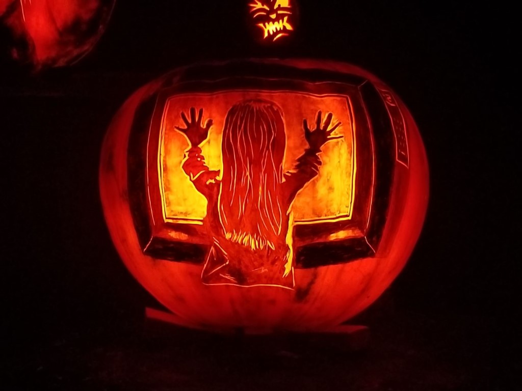 A scene from the horror film Poltergeist carved into a pumpkin