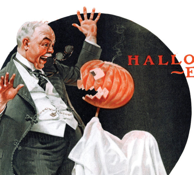 Man being scared by a child holding a Jack O'Lantern