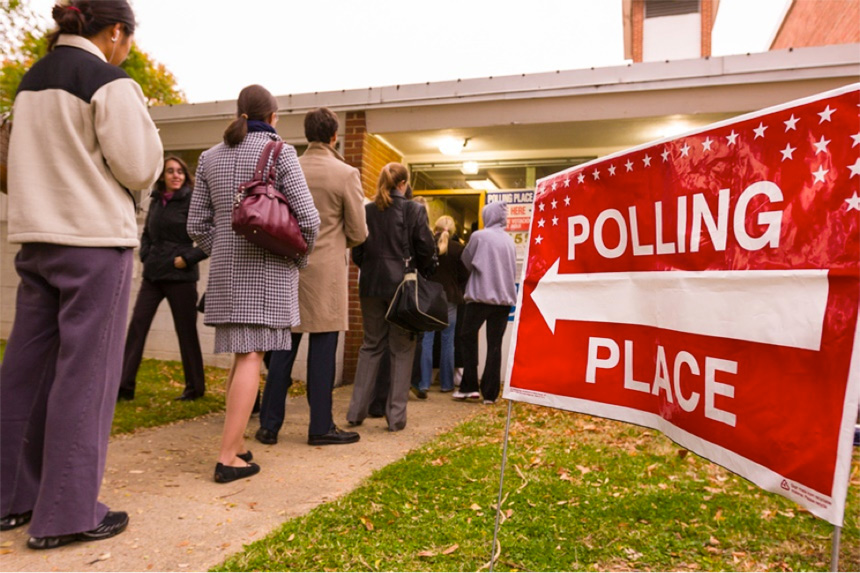 Voters standing in line outside of a polling place